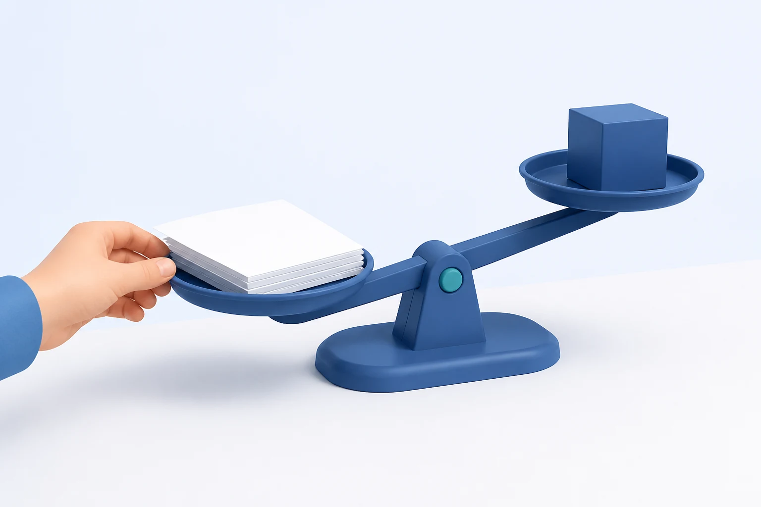 A two-pan balance scale on a desk with a stack of blank sheets on the lower pan and a solid blue cube on the raised pan; a hand steadies the paper side